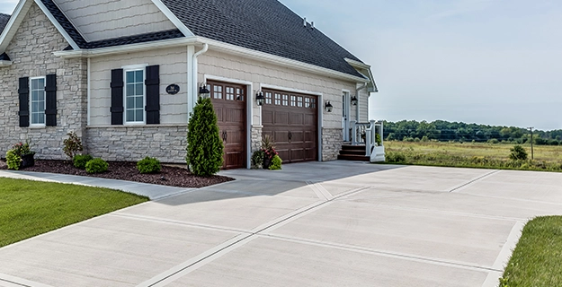 A home with a large pressure-washed concrete driveway.