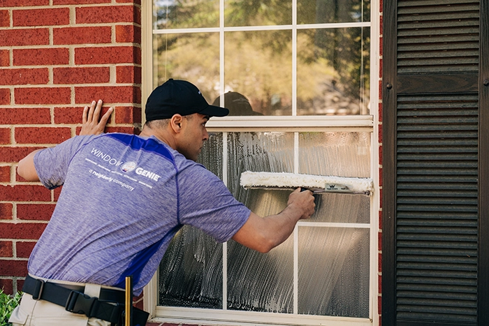 Window Genie tech doing window cleaning in customer's home.