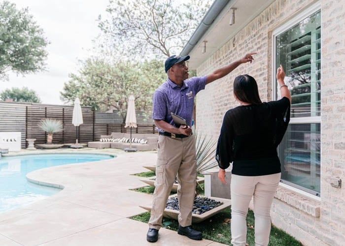 Window Genie Tech going over safety & security film with client