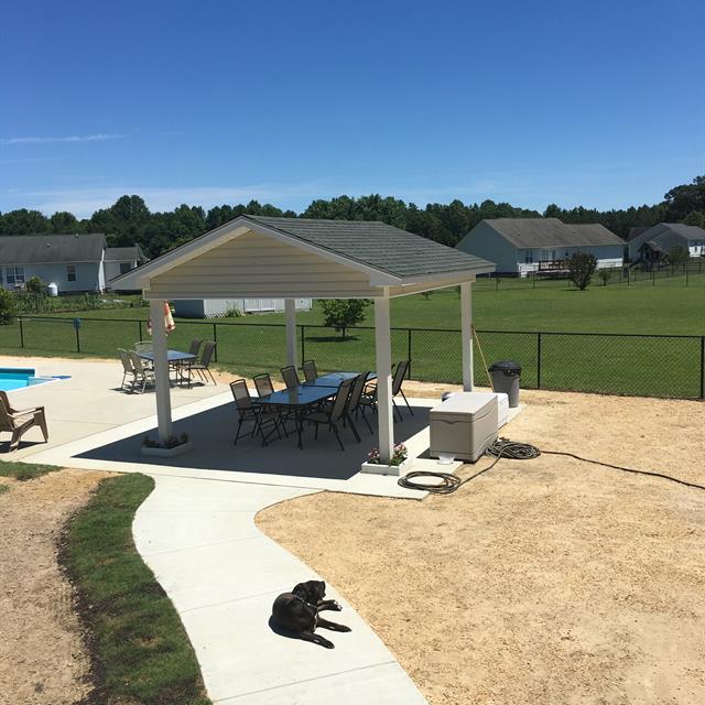 A completed outdoor living space near a pool.