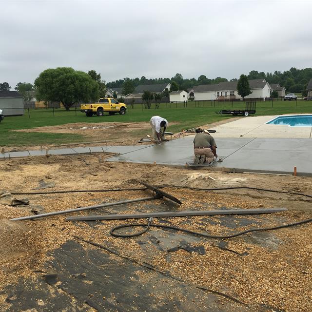 A deck view of two guys working a pathway.