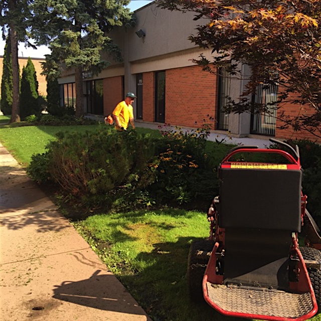 A ground guy working on lawn maintenance.
