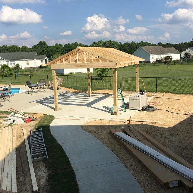 A partially completed construction near the pool.