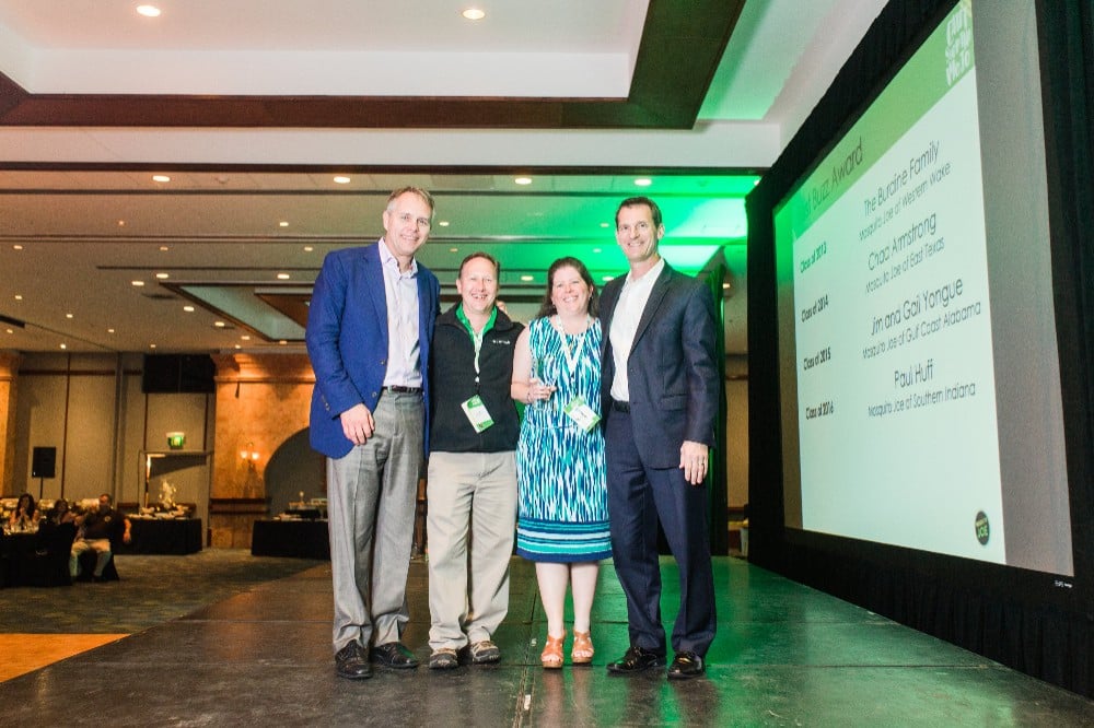 Gail and Jim Yongue receiving an award from the Mosquito Joe franchisor for best customer service.