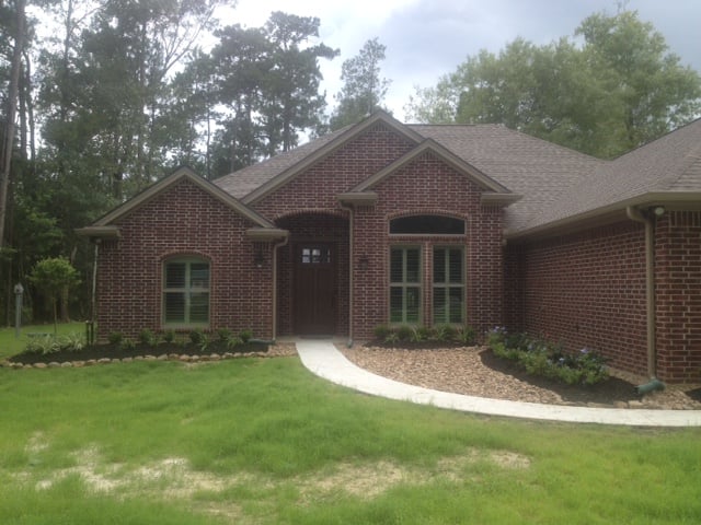 Front of brick house with grass yard