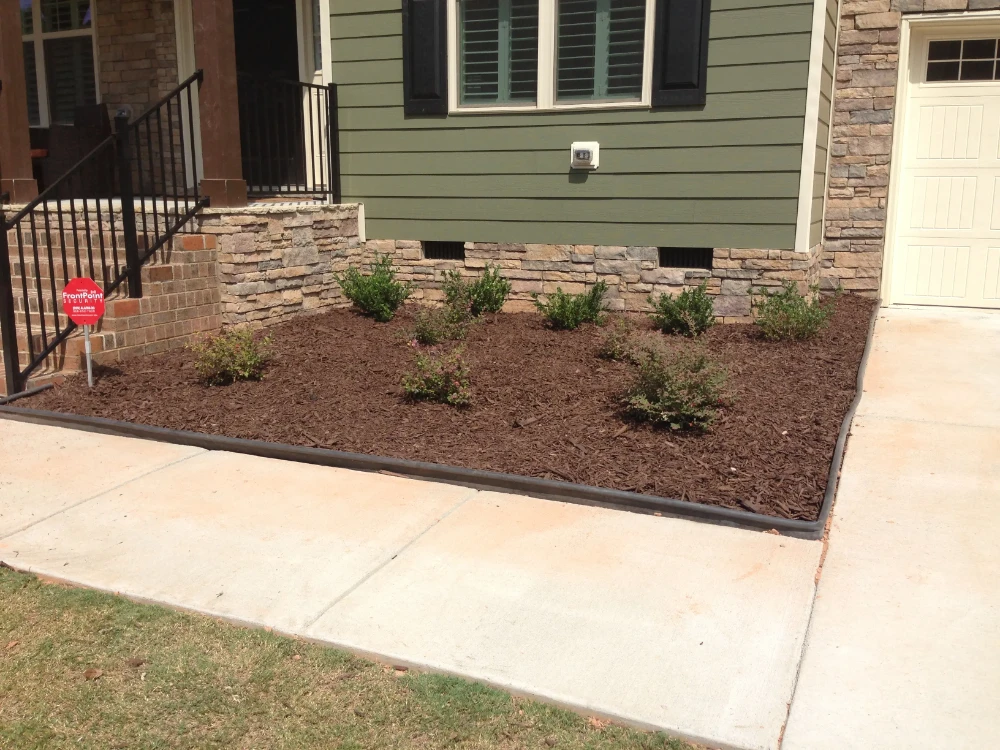 Front of green home with dirt yard