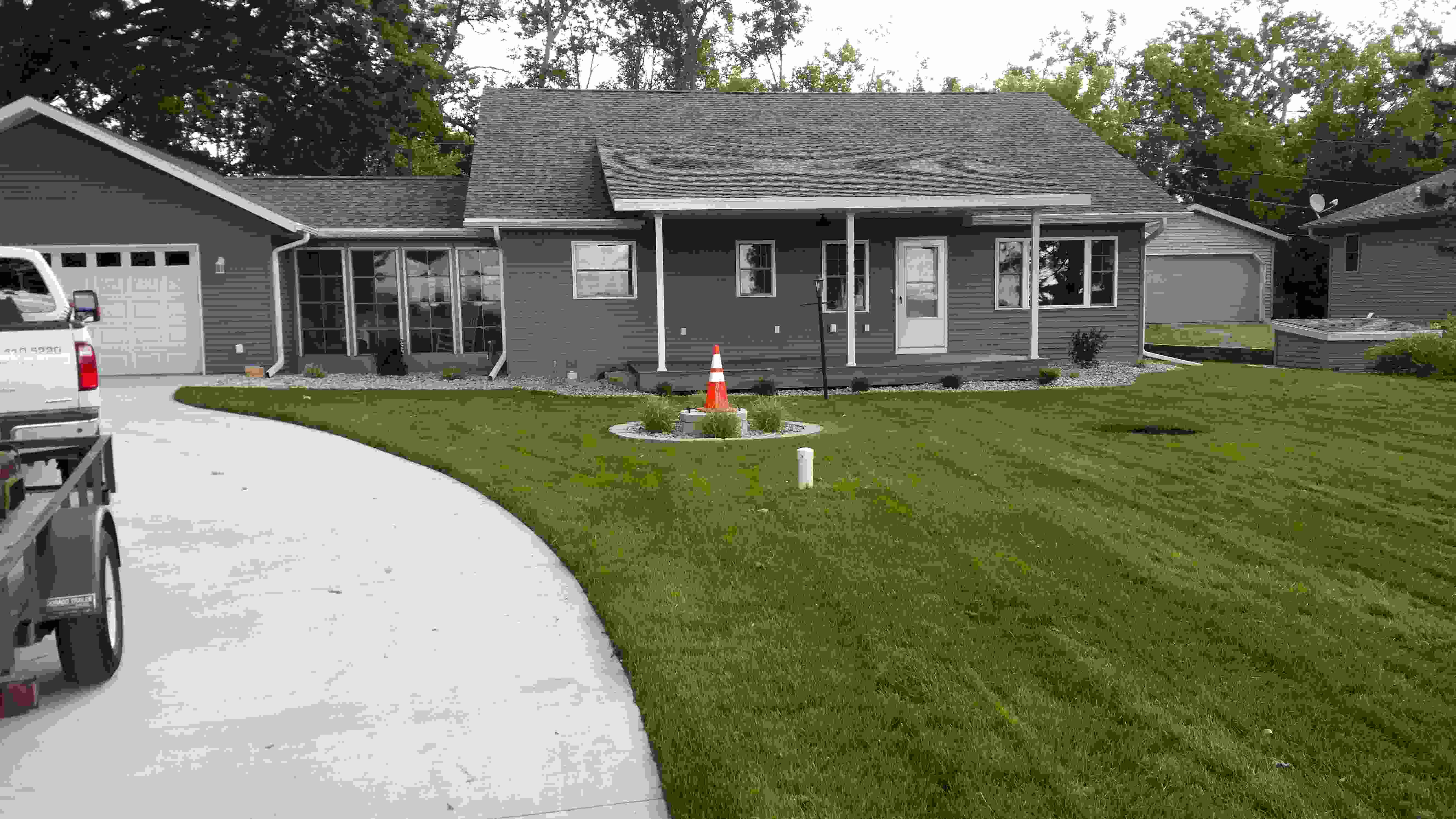 Driveway, well manicured lawn and front of house