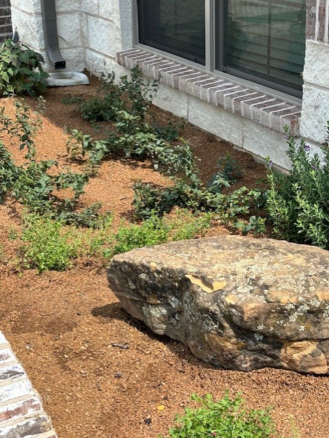 Granite in shrub bed