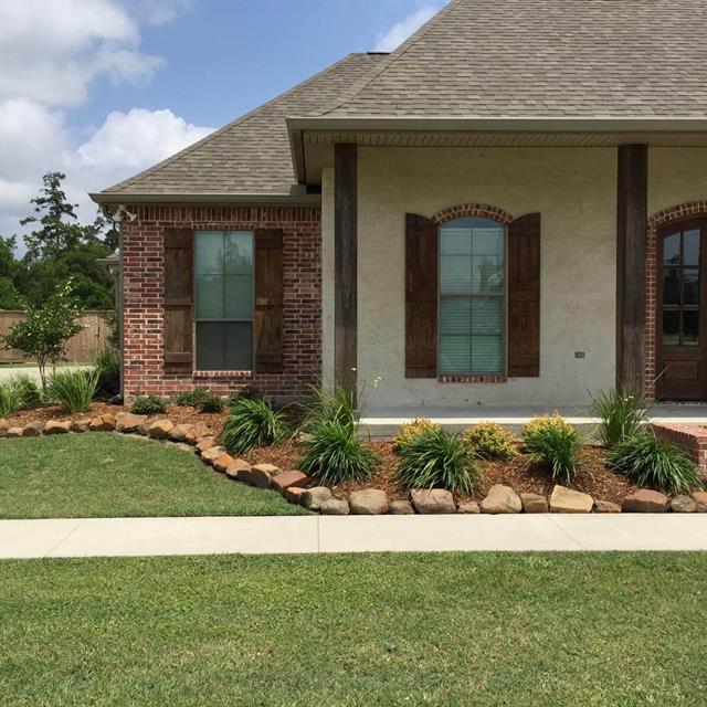 Grass yard and stones in front of the house