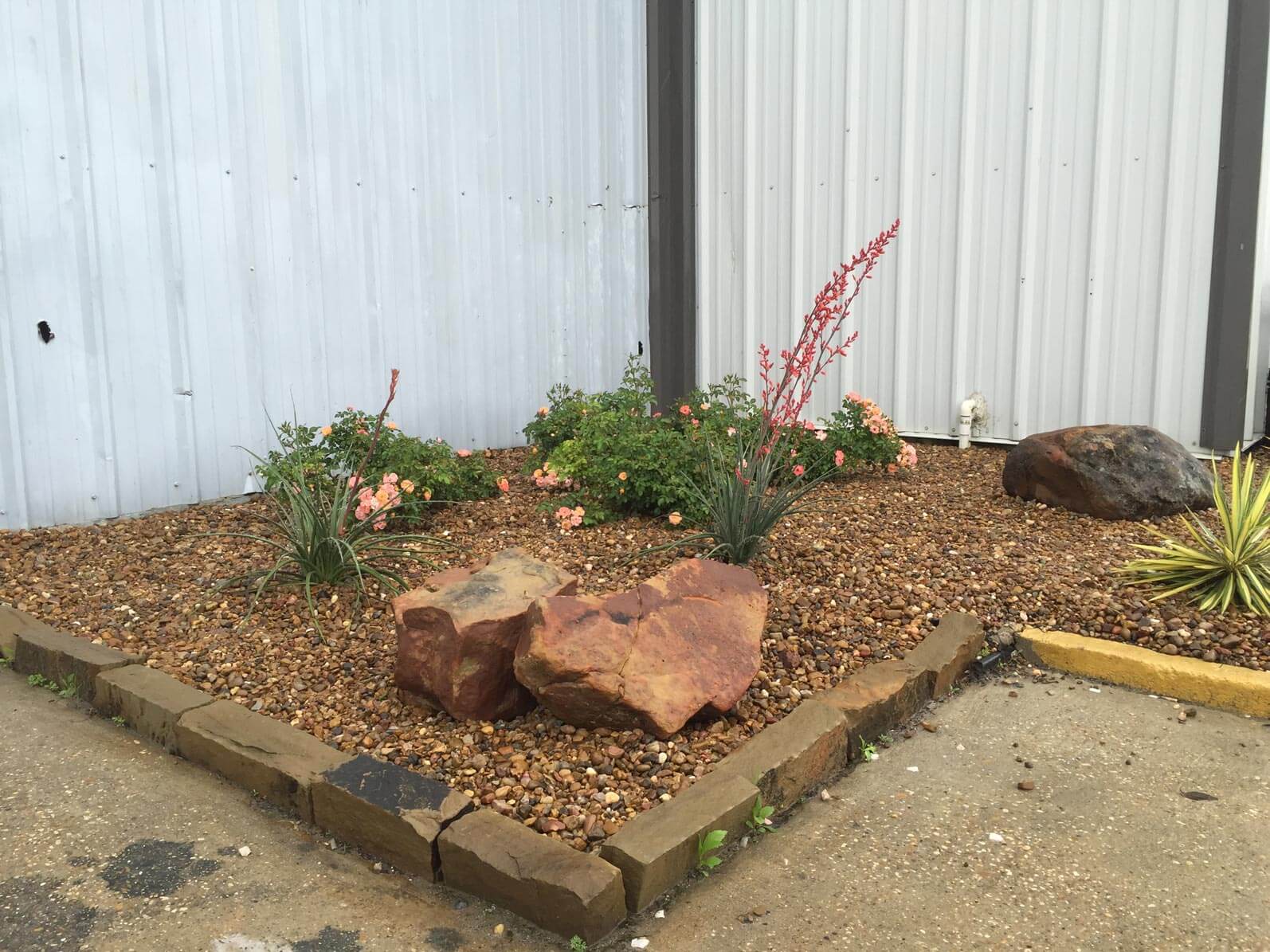 Gravel landscaping along white fence