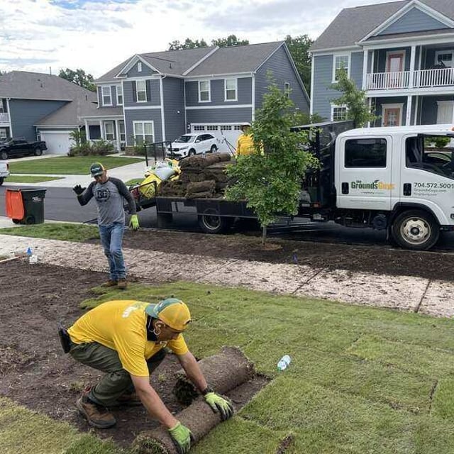 Ground Guy's employees laying fresh sod.