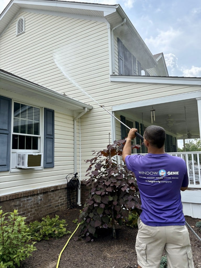 House washing professional cleaning a home's siding
