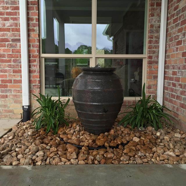 Landscaped front porch with a big vase