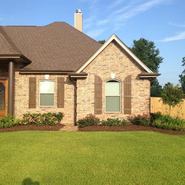 Lawn and garden front of brick house