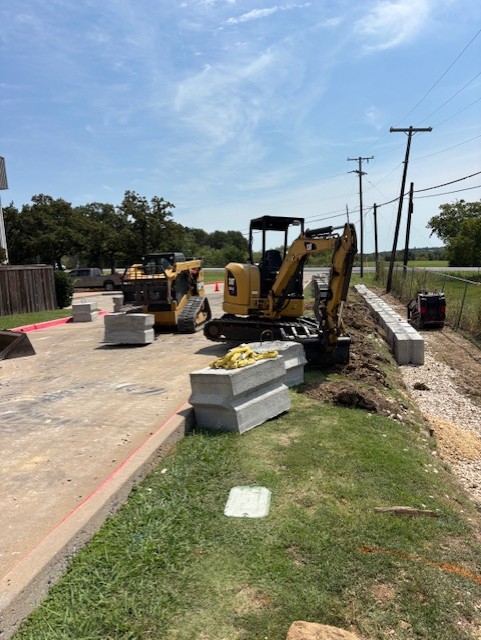 New concrete block retaining wall in place of old crosstie retaining wall