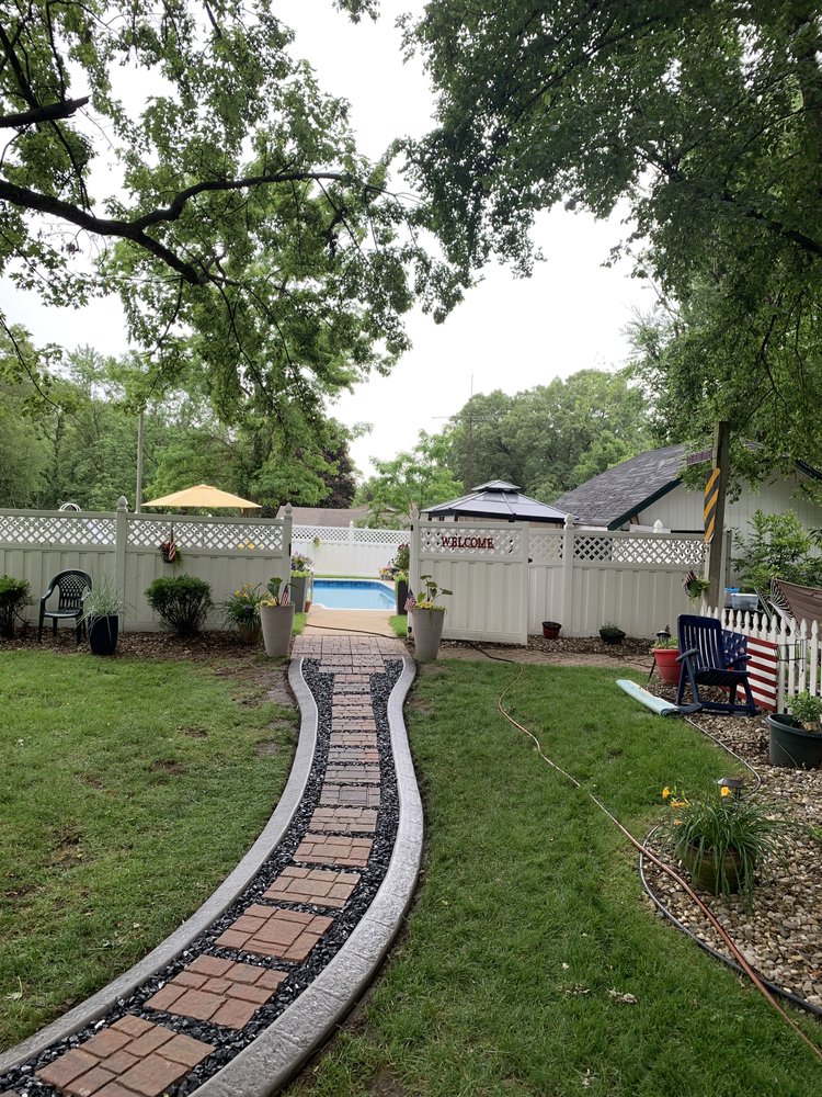Pathway built with pavers, rock, and concrete landscape edging