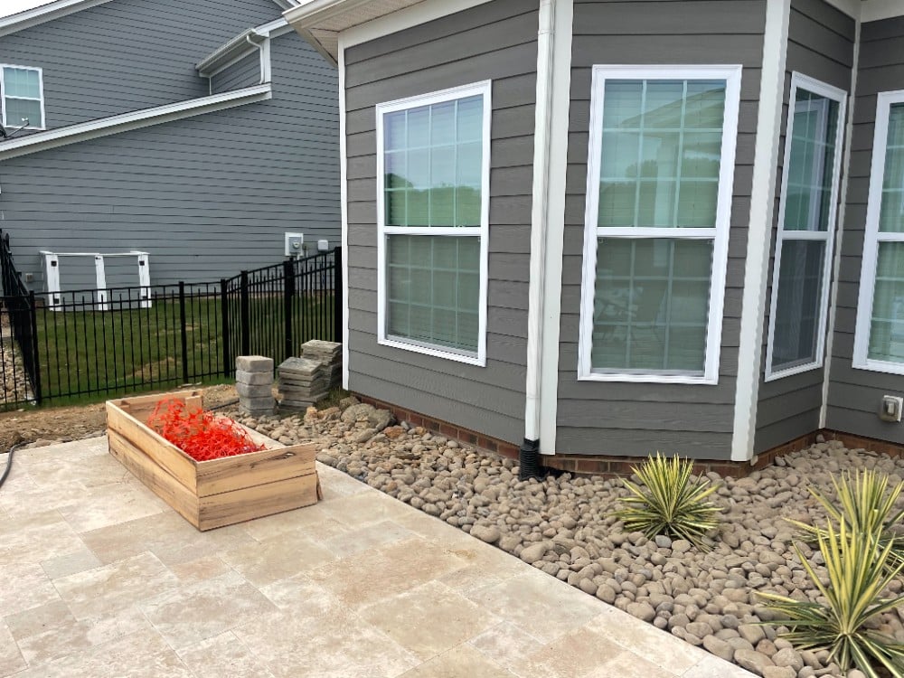 Patio pavers and rock beds are a great alternative to traditional landscaping! The right heat-loving plants add a pop of color and a sleek look.
