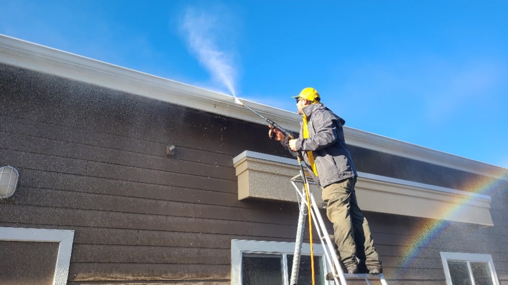 The Grounds Guys professional pressure washing a property.