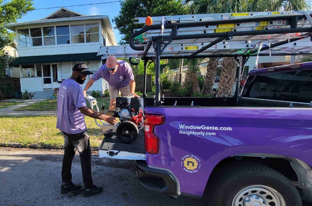 Service professionals unloading pressure washer
