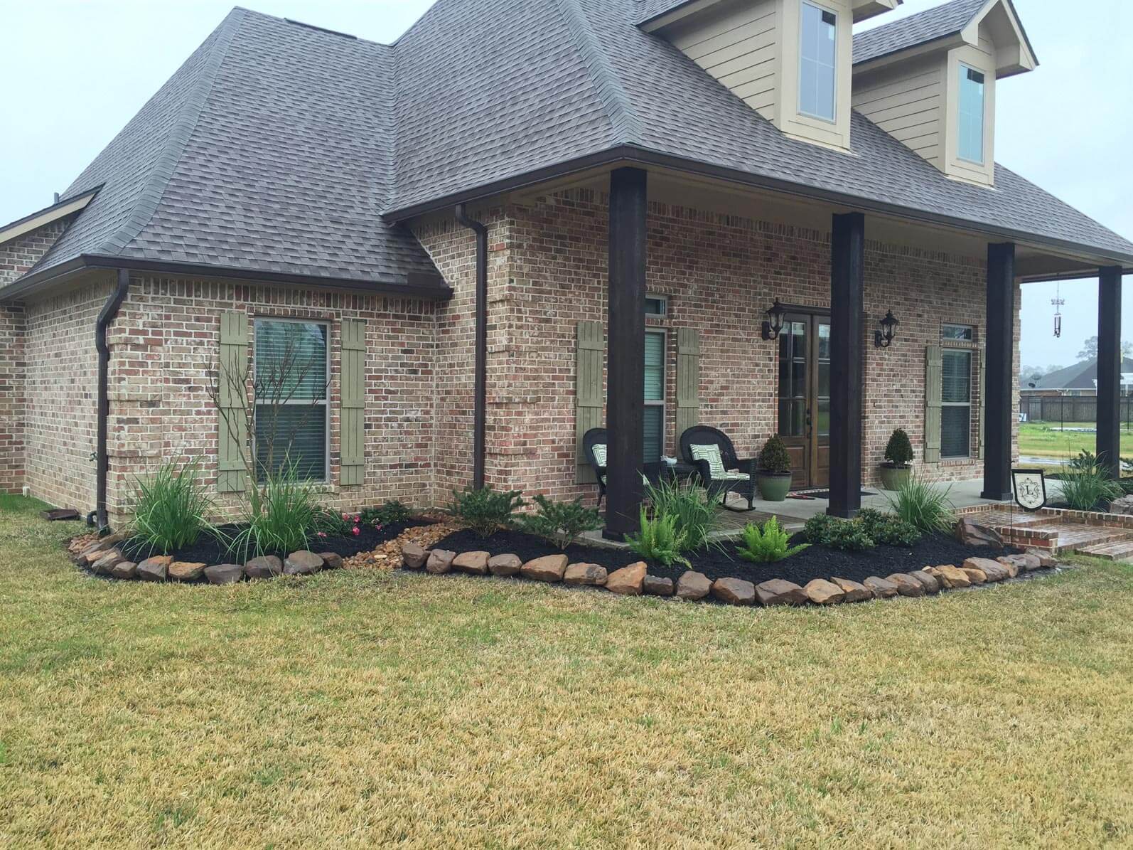 Side view of front of brick house with grass yard