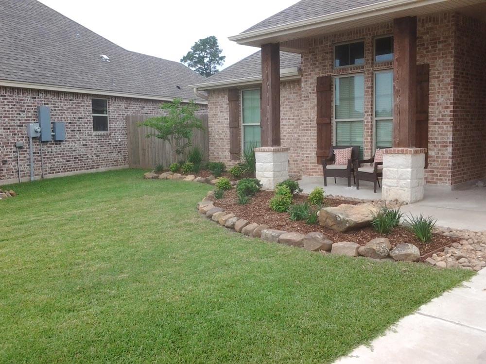 Side view of front of brick house with grass yard