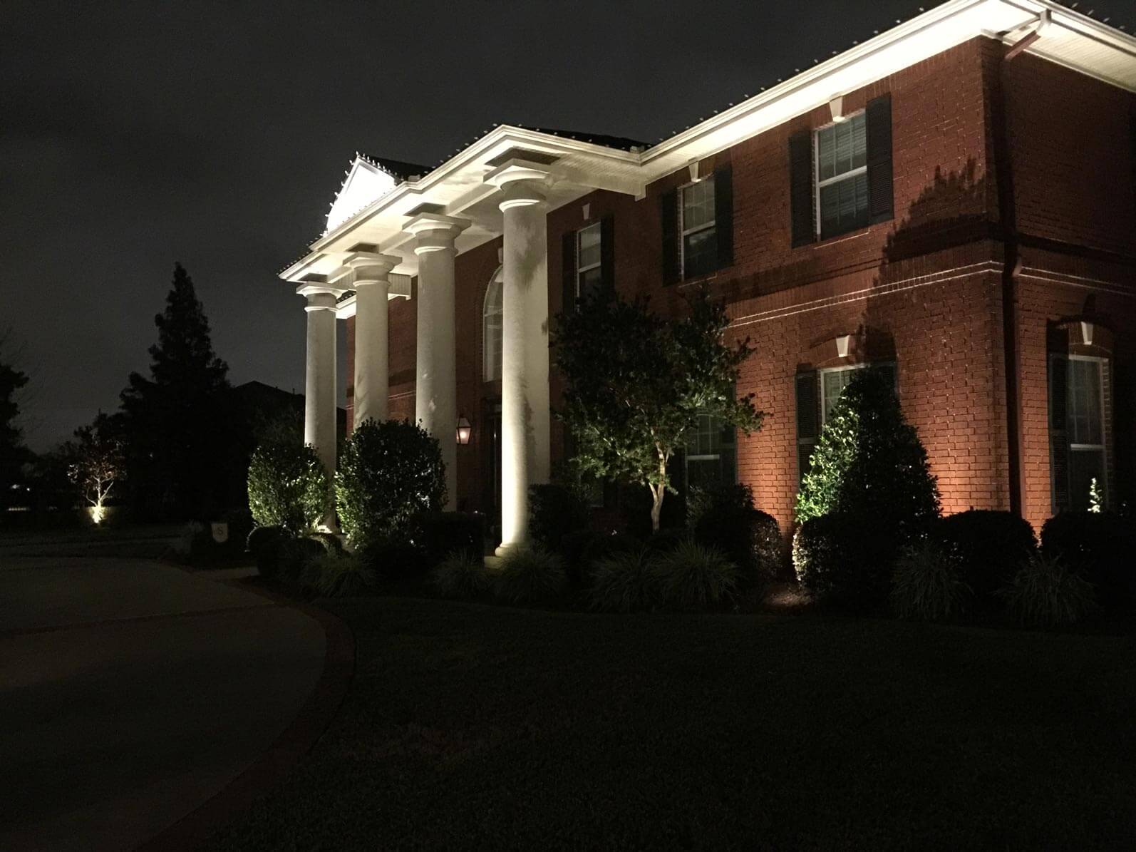 Side view of front of house with night lighting 