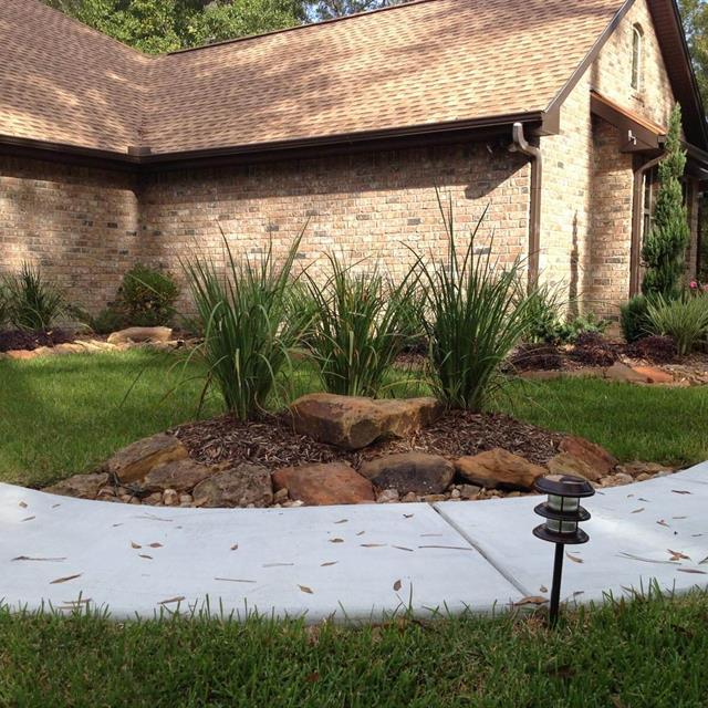 Side view of grass yard and garden