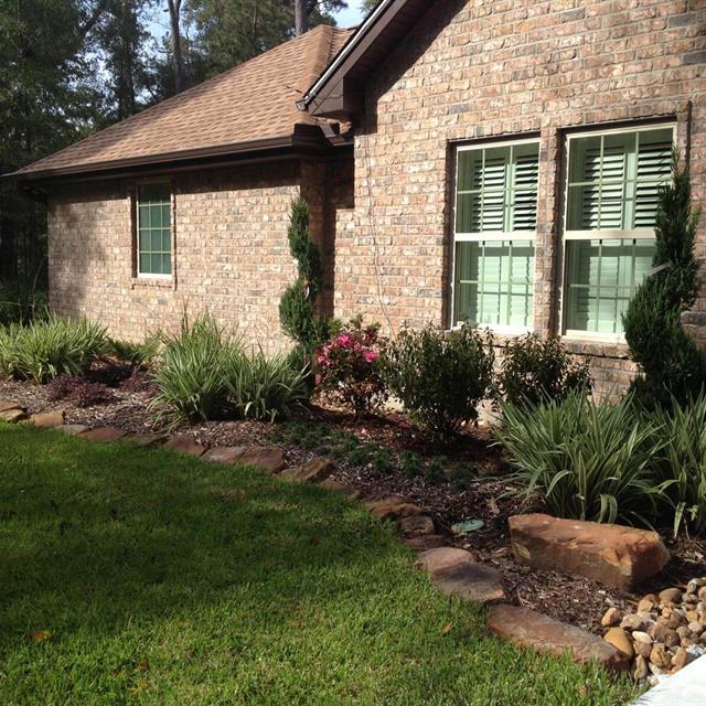 Soil and stone landscape on the side of the brick house