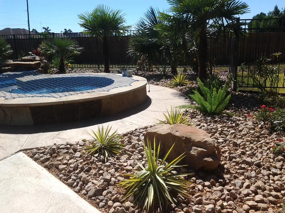 Stone landscape with desert plants behind spa