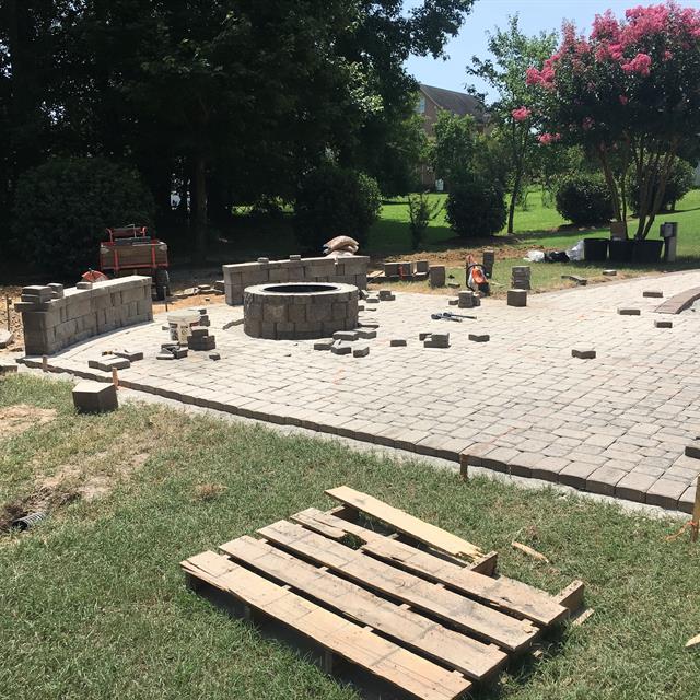 Stone tile paving in a garden with the machinery.