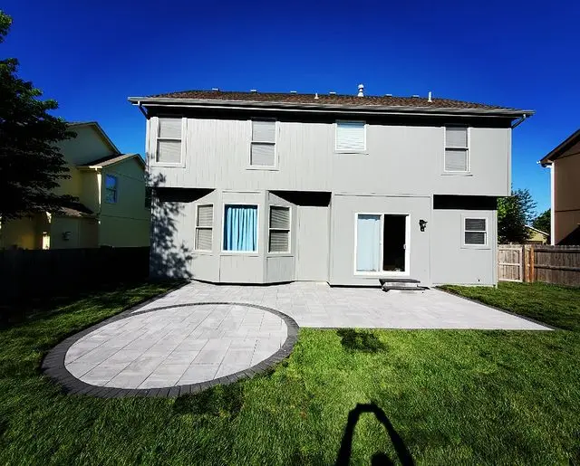 backyard stone patio with circular edition