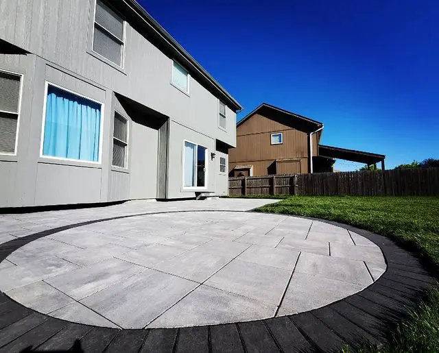 round stone patio feature of backyard