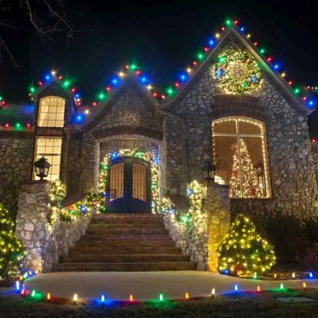 holiday lighting on a house at night