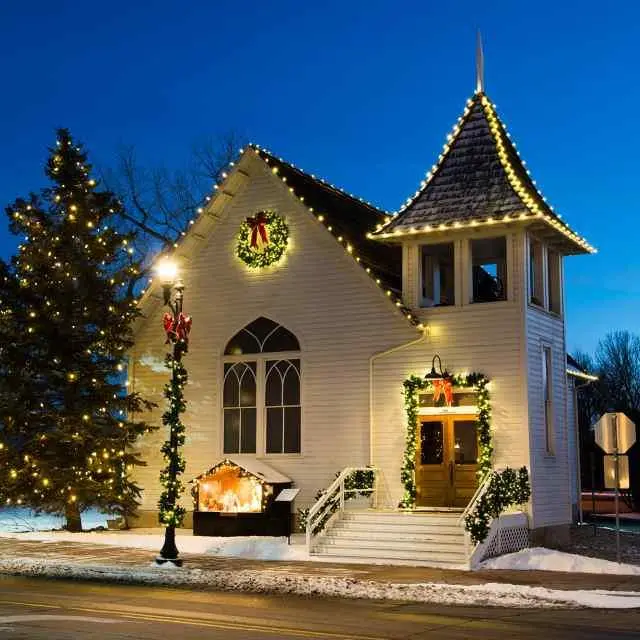 church with holiday lights at night