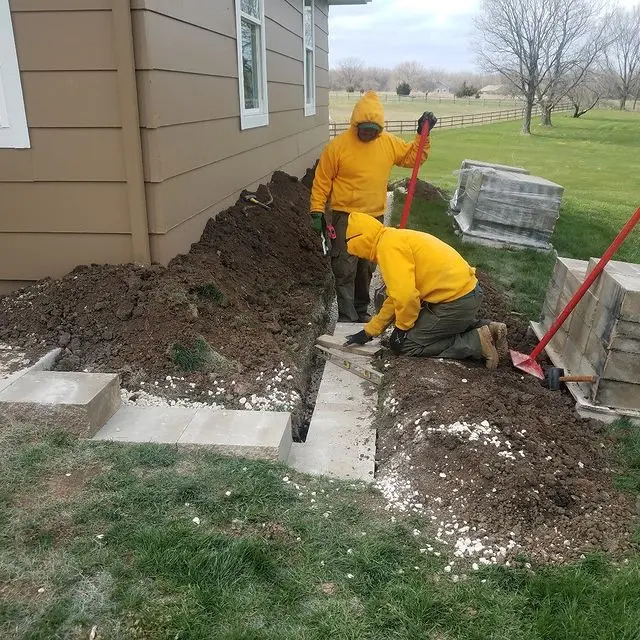 technicians building a raised flower bed