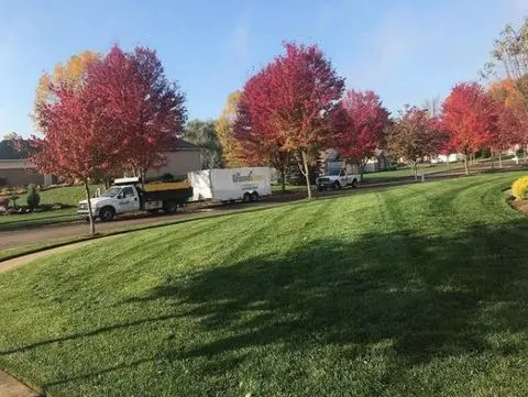 grounds guys truck in front of manicured lawn