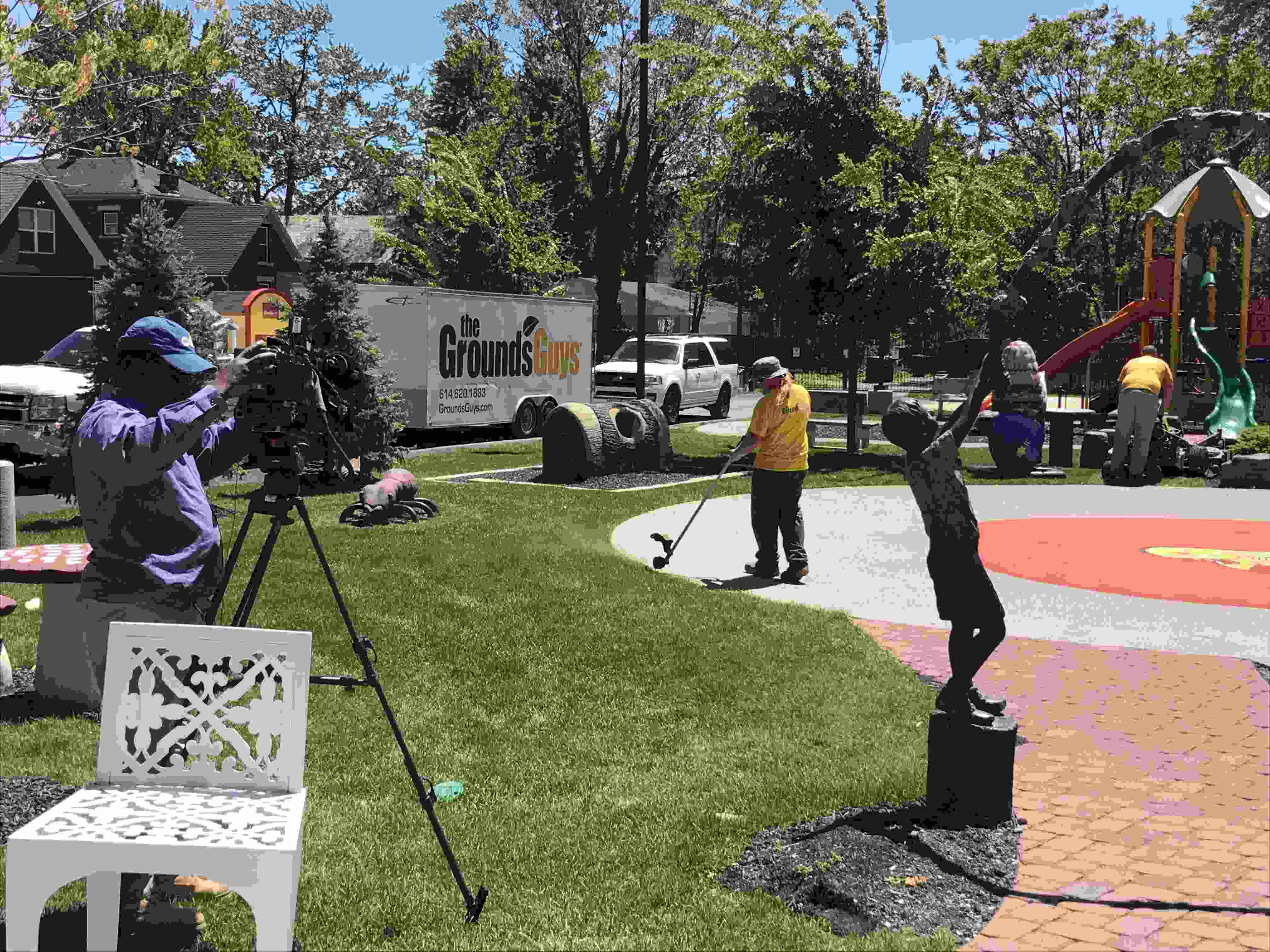 The grounds guys being filed while at work.