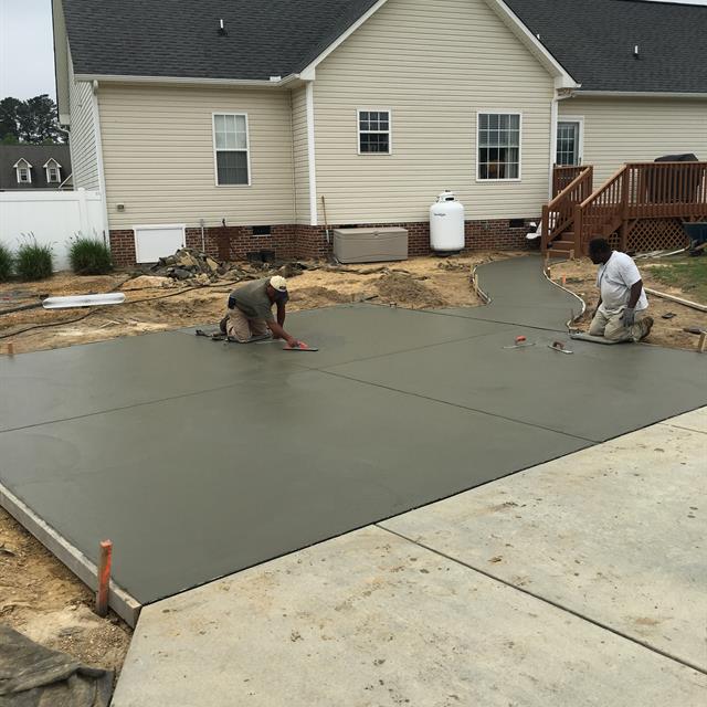 Two workers working on the construction of the pathway.