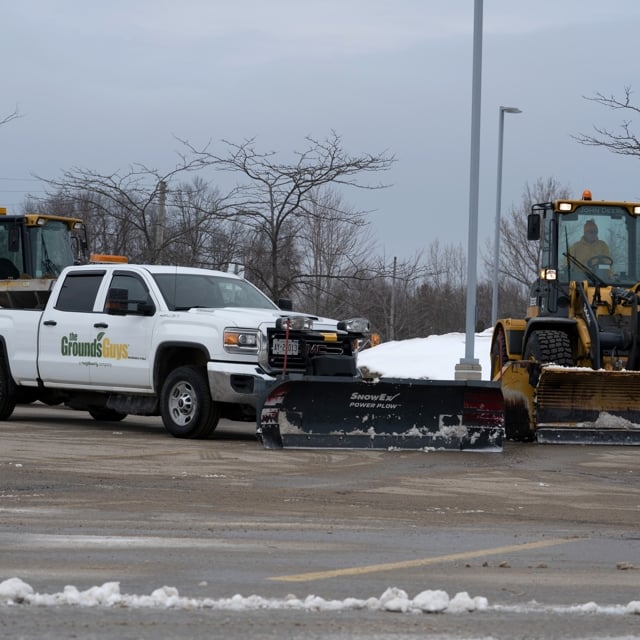 Ground Guy's van removing snow from the road