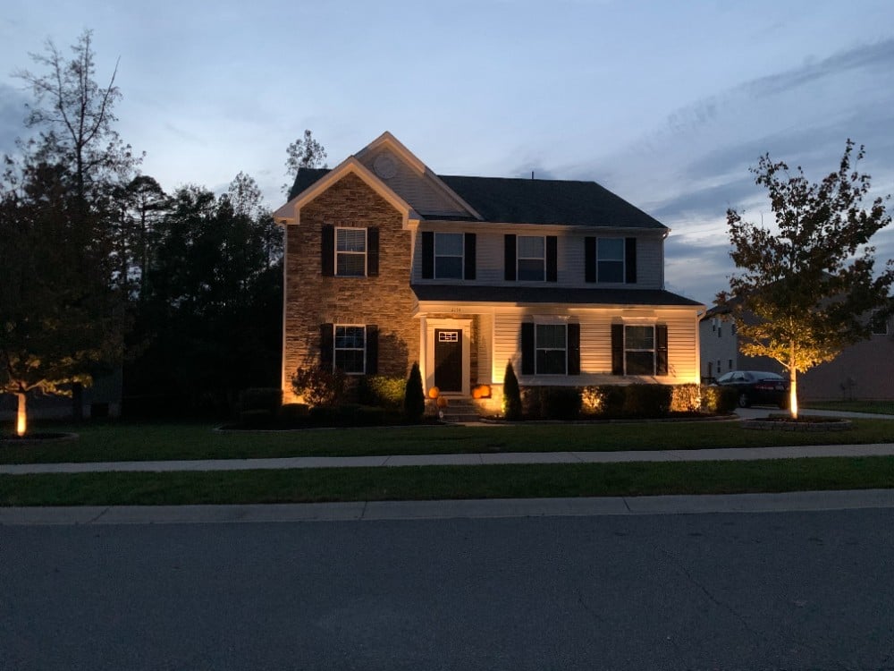 Warm, subtle front yard landscape uplighting.