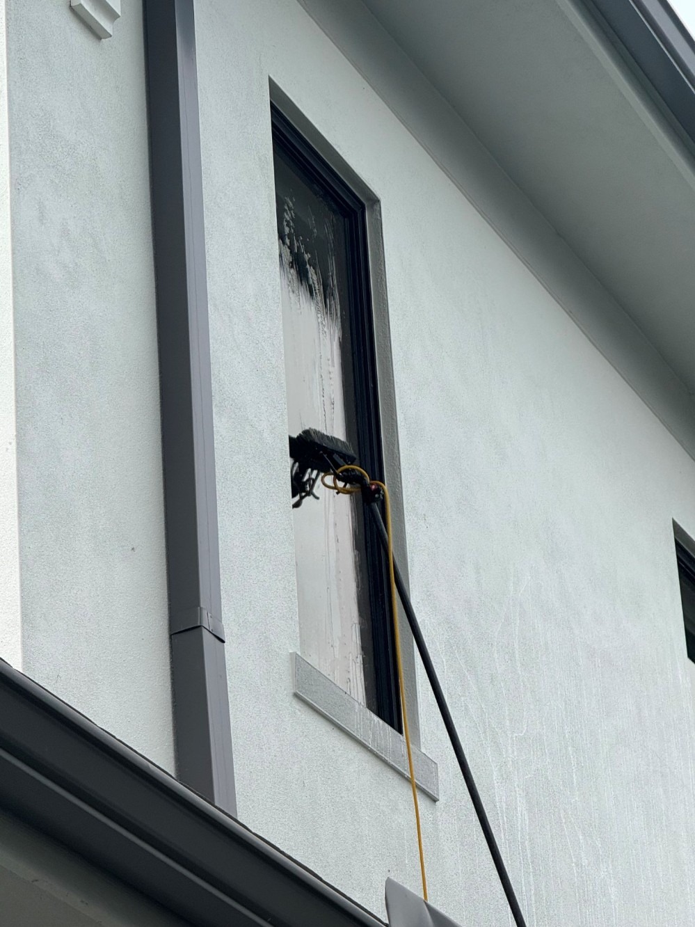 Close up of Water fed pole cleaning 2nd story window
