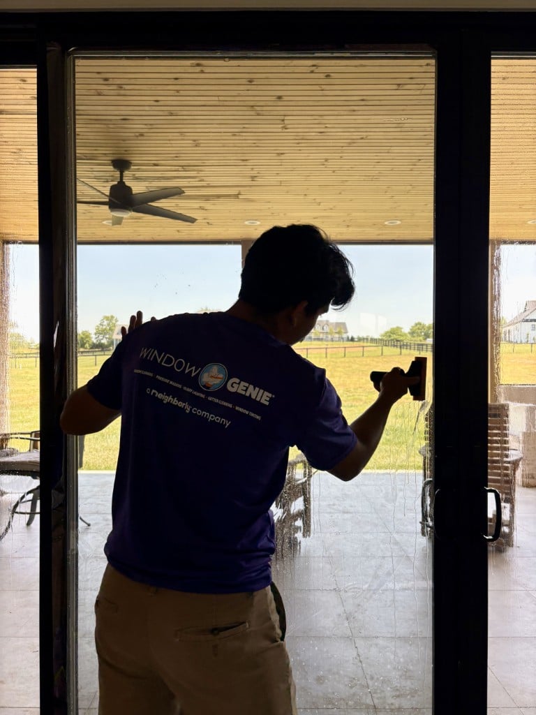 Window tinting professional applying residential window film