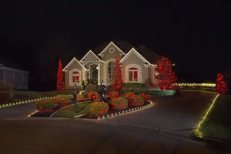 House lit up with Christmas lights professionally installed by Window Genie.
