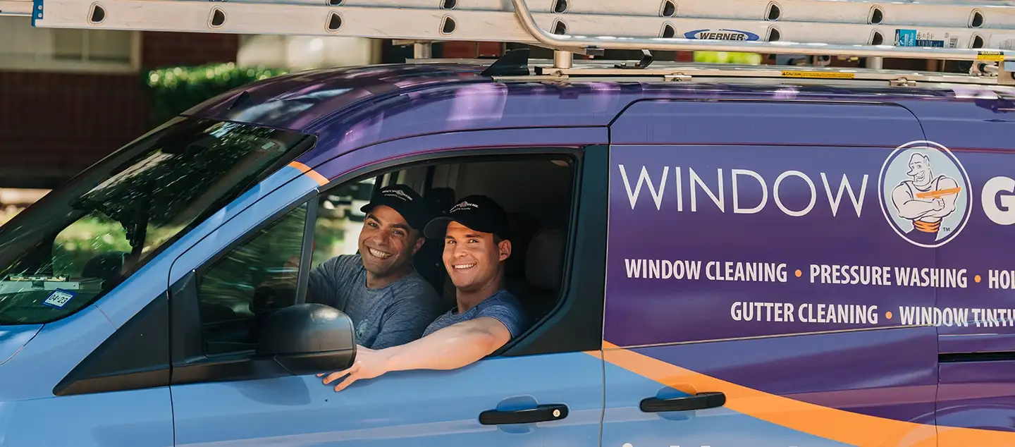 Two Window Genie professionals driving in the van.