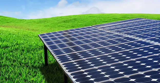 Large solar panel in a grassy field.
