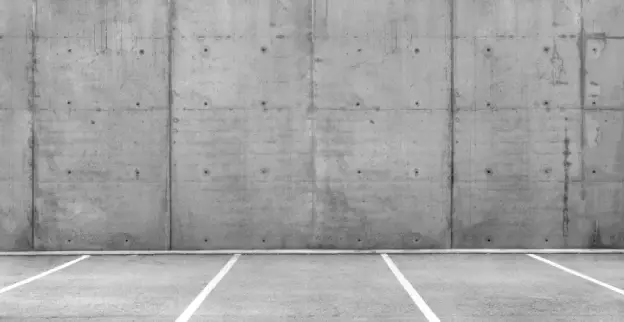 Multiple open parking spaces in a concrete parking garage. 