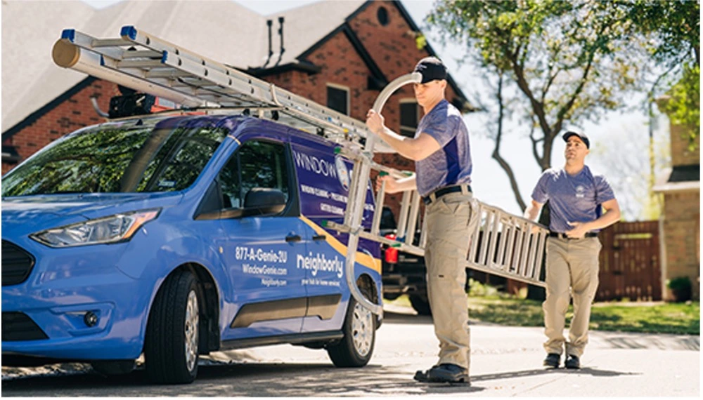 Window Genie professionals carrying ladder