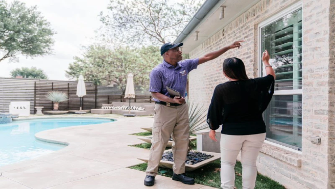 Window Genie Tech going over safety & security film with client