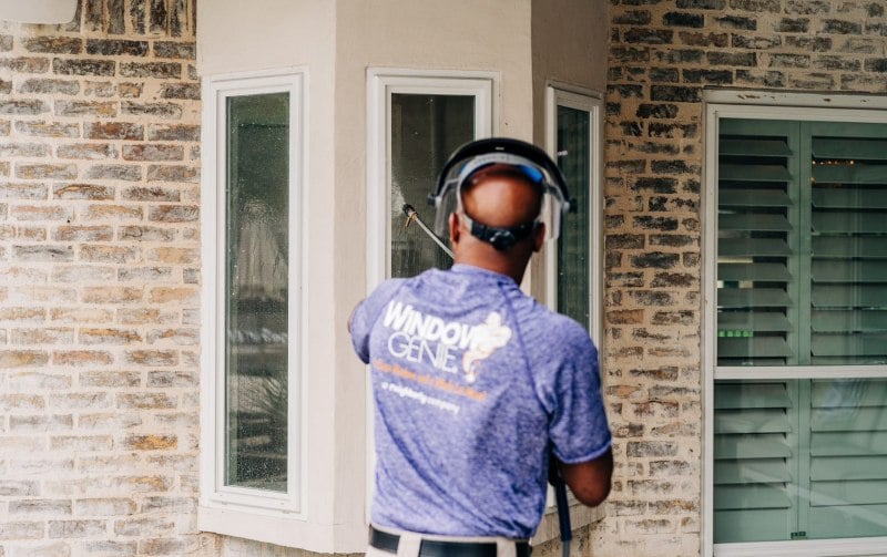 Window Genie tech pressure washing a house in Monroe, GA.