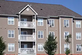 A four-story apartment building with panel siding.